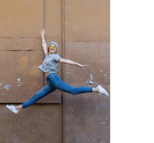 Happy woman jumping with joy, representing the energy and wellness benefits of the Nature's Bounty plant-based eating guide