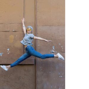 Happy woman jumping with joy, representing the energy and wellness benefits of the Nature's Bounty plant-based eating guide